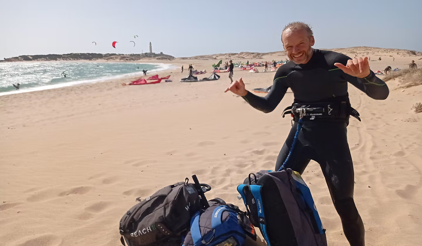 Intermediate kitesurfers practicing with instructor Kevin at High Flyers Tarifa including downwinders, beach activities, and accommodation at High Flyers Kite House with rooftop terrace.